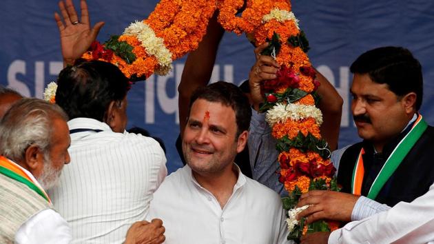 Rahul Gandhi is garlanded by supporters during a campaign meeting ahead of the second phase of elections in Gujarat on December 10. (REUTERS)
