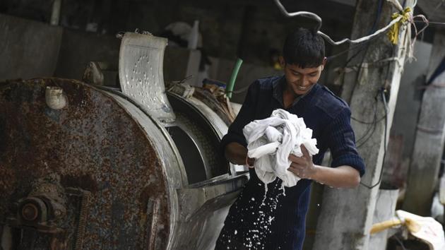 A diligent scrub and soak later, the load moves on to large electric drum dryers that pull out all remnants of dirt, soap and water. From here, the laundry shifts to the clothesline and is left out to dry in the open air. (Burhaan Kinu / HT Photo) 