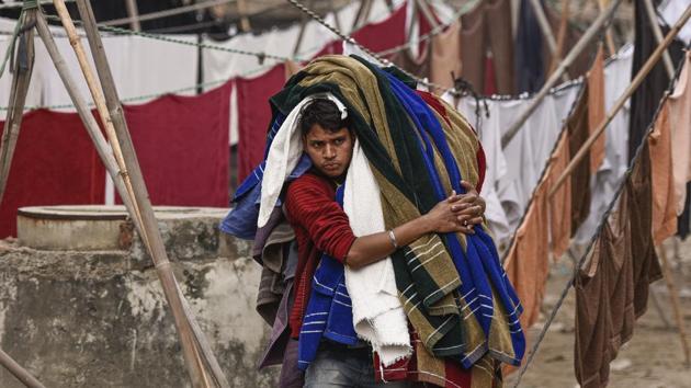 Braving the elements the washermen here depend on the daily influx of laundry to sustain fluctuating incomes. With prices ranging between 10-20 rupees per item, each washerman goes through 50-60 pieces of laundry to cover operational costs and generate a living. (Burhaan Kinu / HT Photo) 