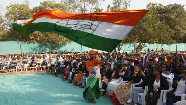 A man waves a Congress flag at a rally in Gujarat.(AP File Photo)