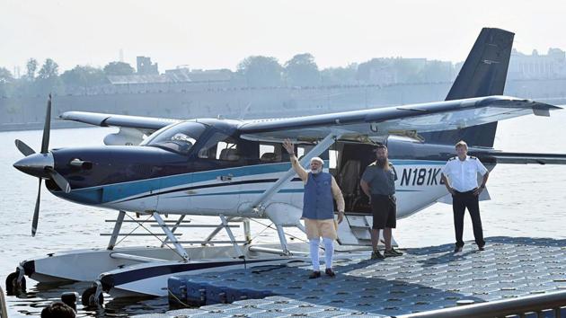 Prime Minister Narendra Modi waves to the crowd as he boards a seaplane on the Sabarmati river front in Ahmedabad on Tuesday.(PTI) Prime Minister Narendra Modi waves to the crowd as he boards a seaplane on the Sabarmati river front in Ahmedabad on Tuesday.(PTI)