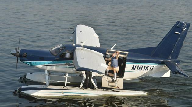 Prime Minister Narendra Modi waves to the crowd as he returns from Dharoi Dam in Mehsana district to Sabarmati riverfront by a sea-plane, in Ahmedabad on Tuesday.(PTI) Prime Minister Narendra Modi waves to the crowd as he returns from Dharoi Dam in Mehsana district to Sabarmati riverfront by a sea-plane, in Ahmedabad on Tuesday.(PTI)