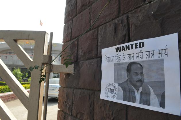 NSUI workers pasted a poster of minister of state for general administration Lal Singh Arya at the gate of state BJP office in Bhopal (Mujeeb Faruqui/HT Photo) NSUI workers pasted a poster of minister of state for general administration Lal Singh Arya at the gate of state BJP office in Bhopal (Mujeeb Faruqui/HT Photo)
