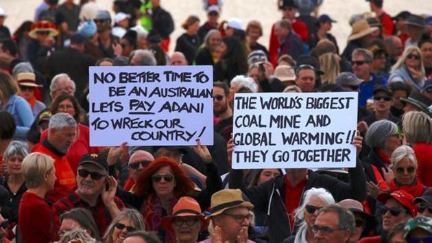 Protestors hold signs as they participate in the National Day of Action against the Indian mining company Adani's planned coal mine project in north-east Australia, at Sydney's Bondi Beach on October 7. (Reuters file) Protestors hold signs as they participate in the National Day of Action against the Indian mining company Adani's planned coal mine project in north-east Australia, at Sydney's Bondi Beach on October 7. (Reuters file)