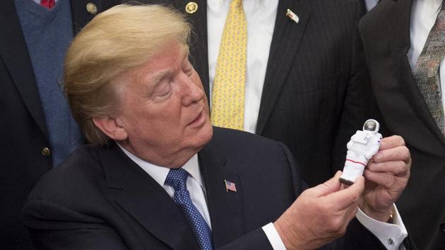 US President Donald Trump holds an astronaut toy after a signing ceremony for Space Policy Directive 1 at the White House in Washington, on Monday. (AFP) US President Donald Trump holds an astronaut toy after a signing ceremony for Space Policy Directive 1 at the White House in Washington, on Monday. (AFP)