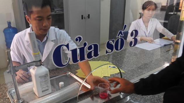 Staff hands a dose of methadone to a recovering drug addict at a treatment clinic in Bac Giang. The government has acknowledged the need to reform the facilities and has softened drug policies, piloting community-based treatment and methadone clinics. Trung also insists his daily dose of methadone is the only effective treatment he’s had. (AFP) 