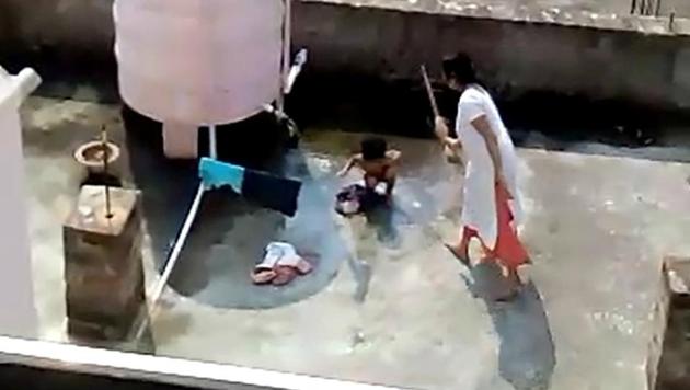 In the video, the woman Pranati Roul (38) is seen beating the bare-bodied girl with hand and then with the rear of a broomstick as the child is washing clothes near a water tank in CDA Sector-11 area. The video appears to be have been shot by a neighbour. (Source: Video) In the video, the woman Pranati Roul (38) is seen beating the bare-bodied girl with hand and then with the rear of a broomstick as the child is washing clothes near a water tank in CDA Sector-11 area. The video appears to be have been shot by a neighbour. (Source: Video)