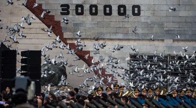 Doves are released during a memorial ceremony at the Nanjing Massacre Memorial Hall in Nanjing. (AFP Photo) Doves are released during a memorial ceremony at the Nanjing Massacre Memorial Hall in Nanjing. (AFP Photo)