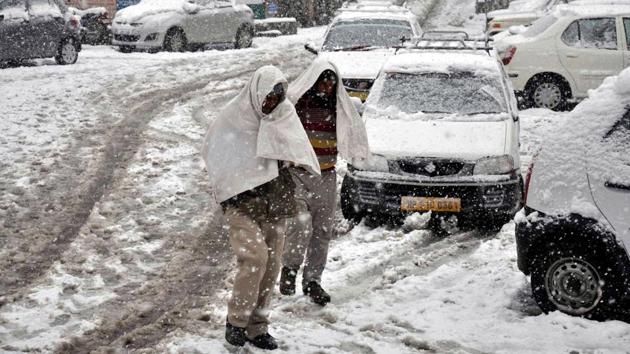 Snowfall was also recorded in Bharmaur in Chamba district, Solang Valley in Manali district and Keylong in Lahaul-Spiti district. People walk through fresh snow at Khajjiar road, Dalhousie in Chamba district. (HT Photo) 