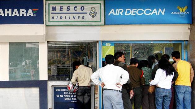 People queue up at an Air Deccan counter outside the Delhi airport in February 2006. The airline, which merged with Kingfisher Airlines, was grounded in 2012 due to Kingfisher’s financial troubles.(HT File Photo)