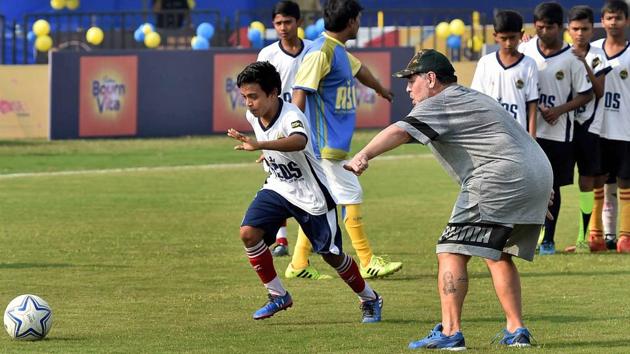 Maradona instructs a young footballer during the workshop. (PTI)