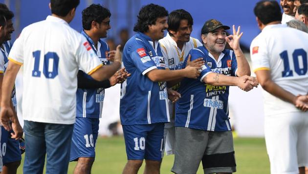 Diego Maradona (2R) is all smiles while greeting some guests present. (AFP)