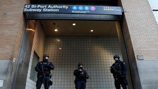 Police officers stand guard outside the closed New York Port Authority Subway entrance following an explosion, in New York City, on Monday.(Reuters file)