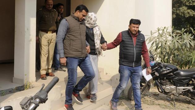 The boy who killed his mother and sister being taken by police personnel for medical tests in Greater Noida. (Sunil Ghosh/HT Photo)