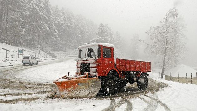 A snow cutter machine cleans out the Gulmarg-Tangmarg highway in Srinagar. Minimum temperatures throughout the Kashmir Valley and Ladakh region remained below freezing point on Wednesday and the ski resort of Gulmarg recorded the coldest temperature at minus 9.8. (Waseem Andrabi / HT Photo) 