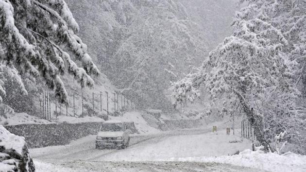A car drives past the scenic beauty of Gulmarg-Tangmarg road. The nearly 300-km long Jammu-Srinagar National Highway, the only all weather road linking Kashmir with the rest of the country, remained closed for the third consecutive day on Wednesday due to multiple landslides in Ramban district, a traffic official said. (Waseem Andrabi / HT Photo) 