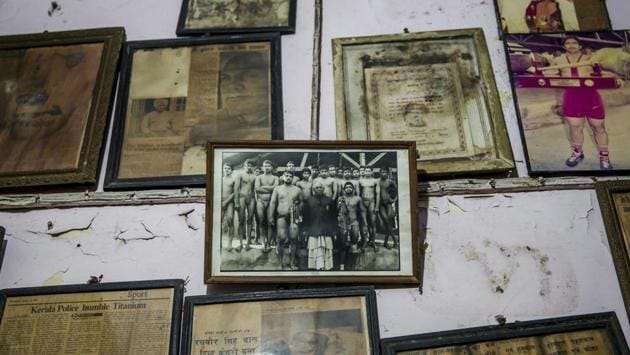Photographs and certificates marking kushti accolades are displayed on a wall at Guru Hanuman Akhada, one of India’s oldest at Sabzi Mandi, in New Delhi. The sport, thought to be 2,000 years old is mentioned in ancient Hindu texts and depicted in temple carvings. Although women wrestlers have made strides recently in India, the vast majority of its participants are men. (Dar Yasin / AP) Photographs and certificates marking kushti accolades are displayed on a wall at Guru Hanuman Akhada, one of India’s oldest at Sabzi Mandi, in New Delhi. The sport, thought to be 2,000 years old is mentioned in ancient Hindu texts and depicted in temple carvings. Although women wrestlers have made strides recently in India, the vast majority of its participants are men. (Dar Yasin / AP)
