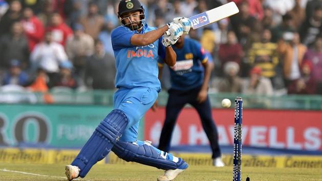 Indian cricket team captain Rohit Sharma hits a maximum during his double ton against Sri Lanka cricket team in the second ODI in at the PCA Stadium in Mohali on Wednesday.(PTI)