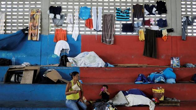 The bleachers at a gym are crowded with belongings of Venezuelan migrants. In Brazil, over half of the almost 40,000 Venezuelans have applied for asylum since arrival, a bureaucratic process that can take two years. The request grants them the right to stay in Brazil and also gives them access to health, education and other social services. (Nacho Doce / REUTERS) The bleachers at a gym are crowded with belongings of Venezuelan migrants. In Brazil, over half of the almost 40,000 Venezuelans have applied for asylum since arrival, a bureaucratic process that can take two years. The request grants them the right to stay in Brazil and also gives them access to health, education and other social services. (Nacho Doce / REUTERS)