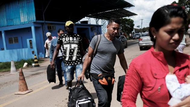 Venezuelans walk towards verification at the Pacaraima border control. Staffed only during the day this sole road crossing along more than 2,100 kms of border with Brazil is in essence open, allowing in nearly 400 people daily. “Brazil’s government is not ready for what is coming,” said Jesús López de Bobadilla, a priest who runs a refugee center on the border. (Nacho Doce / REUTERS) Venezuelans walk towards verification at the Pacaraima border control. Staffed only during the day this sole road crossing along more than 2,100 kms of border with Brazil is in essence open, allowing in nearly 400 people daily. “Brazil’s government is not ready for what is coming,” said Jesús López de Bobadilla, a priest who runs a refugee center on the border. (Nacho Doce / REUTERS)