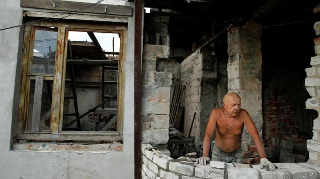 A local resident rebuilds his destroyed house near the airport in Donetsk. As the cold starts to bite, slight relief is brought to few lucky households where water and electricity have been restored, with some even receiving gas and heating. Most damaged homes though stand uninhabitable and cannot be rebuilt. (Alexander Ermochenko / REUTERS) A local resident rebuilds his destroyed house near the airport in Donetsk. As the cold starts to bite, slight relief is brought to few lucky households where water and electricity have been restored, with some even receiving gas and heating. Most damaged homes though stand uninhabitable and cannot be rebuilt. (Alexander Ermochenko / REUTERS)