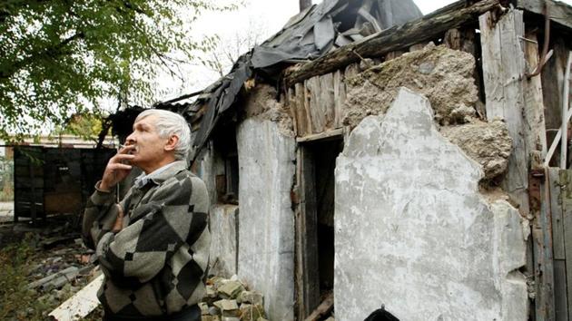 A resident smokes outside his house, which was rubbled in fighting between Ukrainian troops and rebels near Donetsk airport, Ukraine. Ruined houses, shell craters and deserted streets --this is a typical scene in the Oktyabrsky district of Donetsk, the largest city of Ukraine’s pro-Russia rebel region three years after the Crimean annexation and the stalemated War in Donbass. (Alexander Ermochenko / REUTERS) A resident smokes outside his house, which was rubbled in fighting between Ukrainian troops and rebels near Donetsk airport, Ukraine. Ruined houses, shell craters and deserted streets --this is a typical scene in the Oktyabrsky district of Donetsk, the largest city of Ukraine’s pro-Russia rebel region three years after the Crimean annexation and the stalemated War in Donbass. (Alexander Ermochenko / REUTERS)
