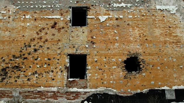 A wall of a former military unit barracks stands pockmarked by shrapnel. The fragile ceasefire agreed in 2015 is often shattered by outbursts of gunfire and explosions of shells. More than 8,000 private homes and over 2,000 apartment houses were badly damaged in Donetsk, according to data provided by its administration. (Alexander Ermochenko / REUTERS) A wall of a former military unit barracks stands pockmarked by shrapnel. The fragile ceasefire agreed in 2015 is often shattered by outbursts of gunfire and explosions of shells. More than 8,000 private homes and over 2,000 apartment houses were badly damaged in Donetsk, according to data provided by its administration. (Alexander Ermochenko / REUTERS)