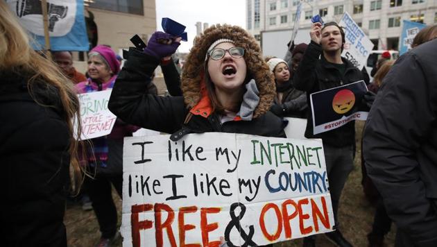Lindsay Chestnut of Baltimore holds a sign that reads "I like My Internet Like I Like my Country Free & Open" as she protests near the Federal Communications Commission (FCC), in Washington, Thursday, Dec. 14, 2017. (AP Photo) Lindsay Chestnut of Baltimore holds a sign that reads "I like My Internet Like I Like my Country Free & Open" as she protests near the Federal Communications Commission (FCC), in Washington, Thursday, Dec. 14, 2017. (AP Photo)