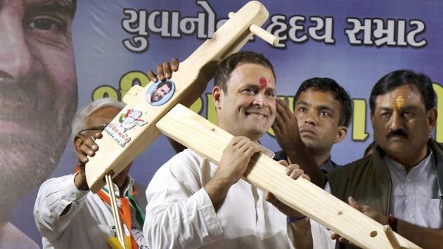 Rahul Gandhi being presented model of a plough by his supporters during a public meeting in Amreli, Gujarat.(PTI File Photo)