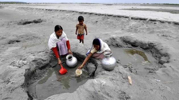 Villagers collect drinking water from the dried bed of Siang River at Berasapori village some 560 kms from Guwahati. (AFP File Photo) Villagers collect drinking water from the dried bed of Siang River at Berasapori village some 560 kms from Guwahati. (AFP File Photo)
