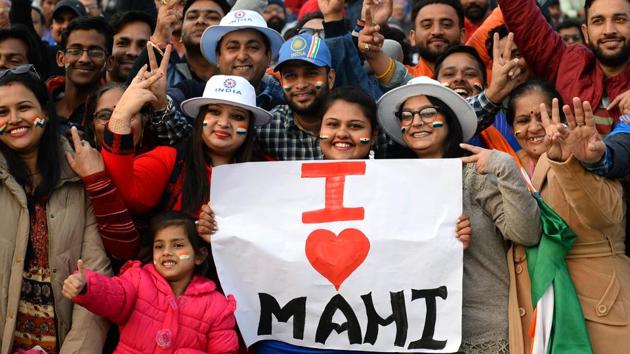 Spectators holding a placard during the match. (AFP)