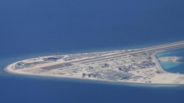 An airstrip, structures and buildings on China's man-made Subi Reef in the Spratly chain of islands in the South China Sea are seen from a Philippine Air Force C-130 transport plane. (AP File Photo) An airstrip, structures and buildings on China's man-made Subi Reef in the Spratly chain of islands in the South China Sea are seen from a Philippine Air Force C-130 transport plane. (AP File Photo)