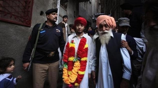 File photo of Sikhs walking through the narrow streets of Peshawar with Gorvindar Singh (centre), one of three Sikhs who was kidnapped for ransom, after his return home on March 1, 2010.(Reuters) File photo of Sikhs walking through the narrow streets of Peshawar with Gorvindar Singh (centre), one of three Sikhs who was kidnapped for ransom, after his return home on March 1, 2010.(Reuters)