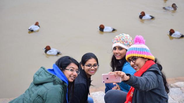 Girls take a selfie at Sukhna Lake on Thursday. (Sikander Singh/HT)