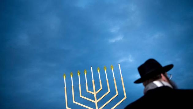 A guest listens during the National Hanukkah Menorah lighting on the Ellipse in Washington, DC. on December 12, 2017. (Brendan Smialowski / AFP) A guest listens during the National Hanukkah Menorah lighting on the Ellipse in Washington, DC. on December 12, 2017. (Brendan Smialowski / AFP)