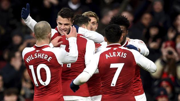 Arsenal FC's Mesut Ozil (centre) celebrates with teammates after scoring against Newcastle United in their Premier League match at the Emirates Stadium in London on Saturday. (AP) Arsenal FC's Mesut Ozil (centre) celebrates with teammates after scoring against Newcastle United in their Premier League match at the Emirates Stadium in London on Saturday. (AP)