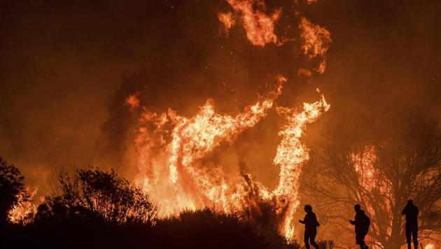 Motorists on Highway 101 watch flames from the Thomas fire leap above the roadway north of Ventura, California. Raging since December 04, wildfire Thomas became state’s third largest blaze on record having already eaten through 256,000-acres (103,600-hectares). (Noah Berger / AP) Motorists on Highway 101 watch flames from the Thomas fire leap above the roadway north of Ventura, California. Raging since December 04, wildfire Thomas became state’s third largest blaze on record having already eaten through 256,000-acres (103,600-hectares). (Noah Berger / AP)