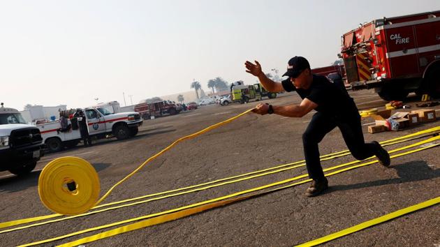 A California fire firefighter unrolls new hoses before they are packed to fight the wildfire at the Ventura County Fairgrounds fire camp. The blaze’s first fatality, fire engineer Cory Iverson, 32, died on Thursday near the Ventura County community of Fillmore. (Patrick T Fallon / REUTERS) A California fire firefighter unrolls new hoses before they are packed to fight the wildfire at the Ventura County Fairgrounds fire camp. The blaze’s first fatality, fire engineer Cory Iverson, 32, died on Thursday near the Ventura County community of Fillmore. (Patrick T Fallon / REUTERS)