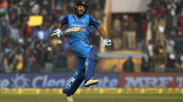 Indian captain Rohit Sharma celebrates his double-century during the second ODI cricket match against Sri Lanka in Mohali on Wednesday. Sharma became the first batsman in the world to hit three ODI double hundreds. (PTI) 