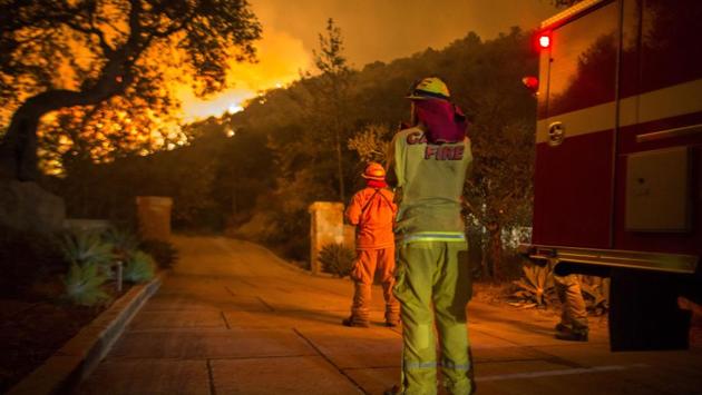 Firefighters watch flames approaches homes in Montecito, California. Everything about the fire has been massive, from a footprint larger than that of many cities to the sheer scale of destruction. The National Weather Service forecasts extreme fire danger or “red flag” conditions through at least Saturday evening. (David McNew / Getty Images / AFP) Firefighters watch flames approaches homes in Montecito, California. Everything about the fire has been massive, from a footprint larger than that of many cities to the sheer scale of destruction. The National Weather Service forecasts extreme fire danger or “red flag” conditions through at least Saturday evening. (David McNew / Getty Images / AFP)
