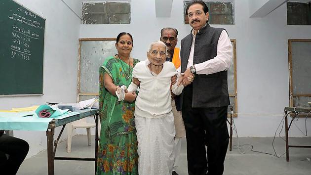 PM Narendra Modi's mother Heeraben Modi arrives to cast her vote, during the second phase of assembly election in Gandhinagar on Thursday. (PTI) 