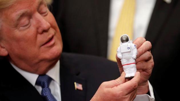 US President Donald Trump holds a space astronaut toy as he participates in a signing ceremony for a new Space Policy Directive at the White House in Washington D.C. on December 11, 2017. (Carlos Barria / REUTERS) US President Donald Trump holds a space astronaut toy as he participates in a signing ceremony for a new Space Policy Directive at the White House in Washington D.C. on December 11, 2017. (Carlos Barria / REUTERS)