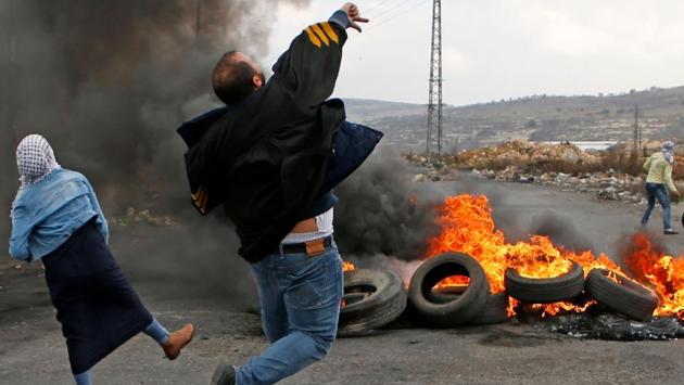Palestinian protestors throw stones towards Israeli security forces during clashes following a demonstration in the West Bank city of Ramallah on December 13, 2017, as protests continued in the region over US President Donald Trump's recognition of Jerusalem as Israel’s capital. (Abbas Momani / AFP) Palestinian protestors throw stones towards Israeli security forces during clashes following a demonstration in the West Bank city of Ramallah on December 13, 2017, as protests continued in the region over US President Donald Trump's recognition of Jerusalem as Israel’s capital. (Abbas Momani / AFP)