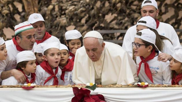 Pope Francis blows a candle on the occasion of his 81st birthday during a private audience with children the Paul VI hall at the Vatican, Sunday, Dec. 17, 2017. (AP Photo) Pope Francis blows a candle on the occasion of his 81st birthday during a private audience with children the Paul VI hall at the Vatican, Sunday, Dec. 17, 2017. (AP Photo)