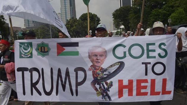 Indonesians march with a banner as they attend a protest against US President Donald Trump's recent decision to recognise Jerusalem as the capital city of Israel, outside the US embassy in Jakarta, on Sunday. (AFP) Indonesians march with a banner as they attend a protest against US President Donald Trump's recent decision to recognise Jerusalem as the capital city of Israel, outside the US embassy in Jakarta, on Sunday. (AFP)
