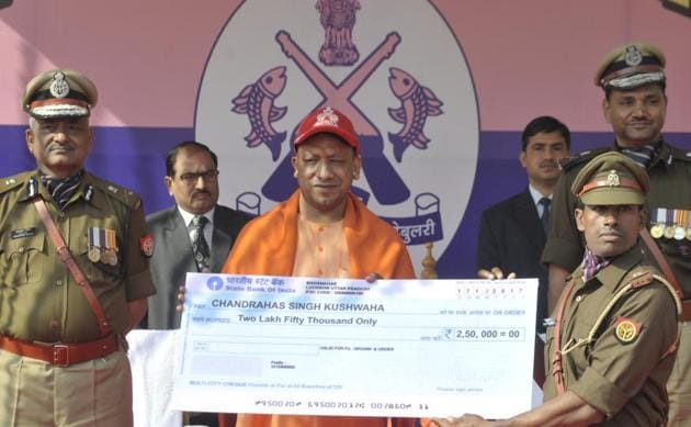 Chief minister presenting a cheque to PAC official Chandrahas Singh Kushwaha who won the medal at the World Police Games. (Deepak Gupta/ HT Photo) Chief minister presenting a cheque to PAC official Chandrahas Singh Kushwaha who won the medal at the World Police Games. (Deepak Gupta/ HT Photo)