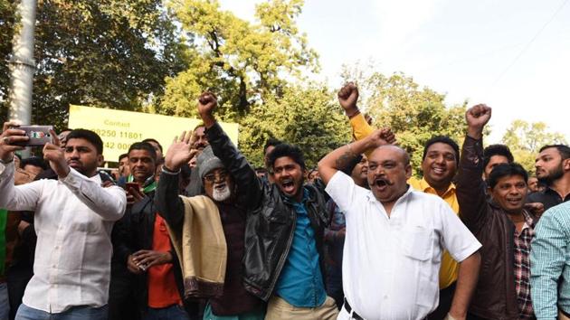 Congress supporters shout slogans near a counting center in Ahmedabad on December 18, 2017. Seven exit polls say the BJP will retain power in Gujarat, where the saffron party has ruled for almost two decades but is battling an agrarian crisis and protests from its loyal Patidar vote bank. (Satish Shankar Bate / HT Photo)