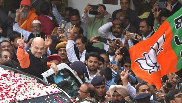 BJP president Amit Shah flashes the victory sign as he is welcomed at the party headquarters in New Delhi on Monday. The party won the assembly elections in both Gujarat and Himachal Pradesh. (PTI Photo) BJP president Amit Shah flashes the victory sign as he is welcomed at the party headquarters in New Delhi on Monday. The party won the assembly elections in both Gujarat and Himachal Pradesh. (PTI Photo)