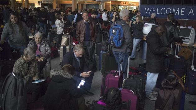 Passengers wait in a dark terminal at Hartsfield-Jackson International Airport in Atlanta on December 17, 2017. A sudden power outage at the airport on Sunday grounded scores of flights and passengers during one of the busiest travel times of the year. (AP) Passengers wait in a dark terminal at Hartsfield-Jackson International Airport in Atlanta on December 17, 2017. A sudden power outage at the airport on Sunday grounded scores of flights and passengers during one of the busiest travel times of the year. (AP)
