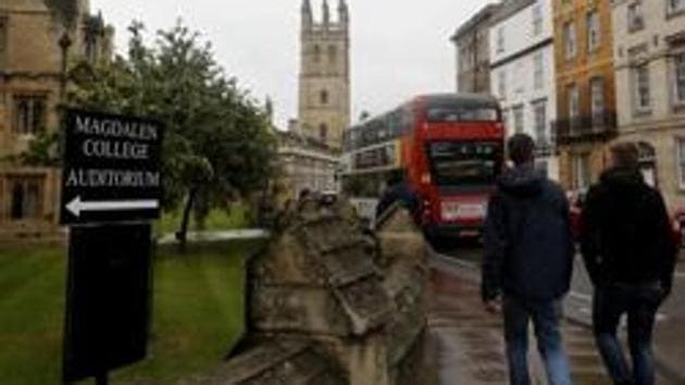 File photo of people walking around Oxford University's campus in England. (AP) File photo of people walking around Oxford University's campus in England. (AP)